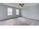 Bright bedroom with neutral walls, soft carpet, two windows and ceiling fan at 1909 Royal Empress Ct, Charleston, SC 29414