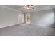 Spacious bedroom featuring neutral walls, plush carpet, ceiling fan, and doorways to bathroom and closet at 1909 Royal Empress Ct, Charleston, SC 29414
