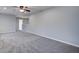 Carpeted open room featuring a ceiling fan, neutral paint, and natural light at 1909 Royal Empress Ct, Charleston, SC 29414