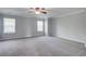 Large bedroom with neutral carpet and walls, featuring two windows and natural light at 1909 Royal Empress Ct, Charleston, SC 29414