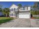 Well-maintained two-story home featuring an attached two car garage and beautifully landscaped front yard at 1909 Royal Empress Ct, Charleston, SC 29414