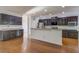 Spacious kitchen featuring dark cabinets, stainless steel appliances, and a convenient breakfast bar at 1909 Royal Empress Ct, Charleston, SC 29414