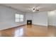 Bright living room with a cozy fireplace, ceiling fan, and large window at 1909 Royal Empress Ct, Charleston, SC 29414