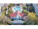 Exterior view of a pool, lounge chairs and a cozy clubhouse set within a lush landscape at 1984 Folly Rd # A306, Charleston, SC 29412