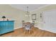 Cozy dining room with a round table and four chairs with a blue accent piece at 1984 Folly Rd # A306, Charleston, SC 29412