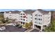 Exterior of a modern condominium building with private balconies, parking, and neat landscaping at 1984 Folly Rd # A306, Charleston, SC 29412