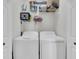 Practical laundry room equipped with a washer, dryer, and storage shelves for convenience at 1984 Folly Rd # A306, Charleston, SC 29412