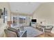 Bright living room featuring a ceiling fan, white accents, and a beautiful outdoor view from the sliding glass door at 1984 Folly Rd # A306, Charleston, SC 29412