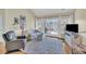 Cozy living room with lots of seating, white accents, and a view of the outdoor balcony at 1984 Folly Rd # A306, Charleston, SC 29412