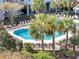Beautiful in-ground pool surrounded by lush landscaping, palm trees, and ample seating area for relaxing at 1984 Folly Rd # A306, Charleston, SC 29412