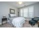The room has a fan, a comfy bed, and a seat near the bright window at 2010 Redback Dr, Summerville, SC 29483
