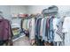 A walk-in closet has storage shelves full of shoes, purses, and clothes to keep organized at 2010 Redback Dr, Summerville, SC 29483