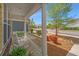 Inviting front porch with white railing, rocking chairs and colorful landscaping at 2010 Redback Dr, Summerville, SC 29483