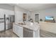 Bright kitchen featuring a large island with granite countertop, stainless steel appliances, and modern cabinetry at 2010 Redback Dr, Summerville, SC 29483