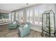 Bright living room with decorative furnishings, plantation shutters and tile floor at 2010 Redback Dr, Summerville, SC 29483