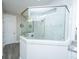A glass partition surrounds the corner shower, a door leads outside the bathroom, and tile flooring is underfoot at 2010 Redback Dr, Summerville, SC 29483