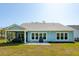 Back exterior of home with screened porch, patio, and well-maintained lawn at 2036 Yaupon Way, Johns Island, SC 29455