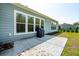 Back of house with windows, a patio with scattered leaves, and a built-in grill at 2036 Yaupon Way, Johns Island, SC 29455