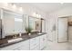 Bathroom with double sinks, granite counters, white cabinets and tiled floors at 2036 Yaupon Way, Johns Island, SC 29455