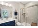 A bathroom featuring a walk-in shower, dark blue vanity, and white toilet at 2036 Yaupon Way, Johns Island, SC 29455