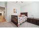 This bedroom features neutral carpet, a wooden bed, and an antique trunk at 2036 Yaupon Way, Johns Island, SC 29455