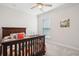This bedroom features neutral paint, a ceiling fan, and a wooden bed at 2036 Yaupon Way, Johns Island, SC 29455