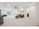 This bonus room features two ceiling fans, neutral carpet, and a leather futon at 2036 Yaupon Way, Johns Island, SC 29455