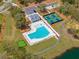 Aerial view of a sparkling community pool, pickleball, and putting green surrounded by lush landscaping at 2036 Yaupon Way, Johns Island, SC 29455