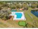 Aerial view of community pool, pickle ball and playground surrounded by trees and pristine landscaping at 2036 Yaupon Way, Johns Island, SC 29455