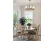 Dining room with elegant chandelier, windows, and view to the backyard at 2036 Yaupon Way, Johns Island, SC 29455