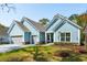 Charming single-story home featuring light blue siding, gray garage doors and a well-manicured lawn at 2036 Yaupon Way, Johns Island, SC 29455