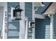 Close-up view highlighting the home's address, exterior lighting, and light blue siding at 2036 Yaupon Way, Johns Island, SC 29455