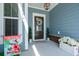 Inviting front porch adorned with a wreath, potted plants, and a 'Welcome' flag at 2036 Yaupon Way, Johns Island, SC 29455