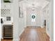 Bright hallway with hardwood floors, white trim, a wine fridge, and an arched doorway at 2036 Yaupon Way, Johns Island, SC 29455