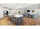 Open kitchen with stainless steel appliances and large central island with breakfast bar at 2036 Yaupon Way, Johns Island, SC 29455