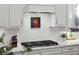 Modern kitchen features a herringbone tile backsplash, gas cooktop, and recessed lighting at 2036 Yaupon Way, Johns Island, SC 29455