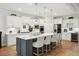 Updated kitchen with stainless steel appliances, white cabinetry, and a gray kitchen island with barstool seating at 2036 Yaupon Way, Johns Island, SC 29455