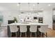 Open concept kitchen with a large island, barstool seating, and stylish pendant lights at 2036 Yaupon Way, Johns Island, SC 29455