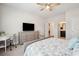 This main bedroom features a ceiling fan, a writing desk, and a connecting door to the on-suite bathroom at 2036 Yaupon Way, Johns Island, SC 29455