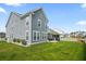Large fenced backyard with lush green grass, white picket fence, and screened-in porch at 204 Corvus St, Summerville, SC 29483