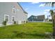 Large backyard area with a white picket fence and a lush green lawn at 204 Corvus St, Summerville, SC 29483