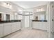Bright bathroom boasts double sink vanity, tile floors, and modern glass enclosed shower at 204 Corvus St, Summerville, SC 29483
