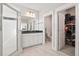 Bright bathroom featuring double sink vanity, walk-in shower, and linen closet access at 204 Corvus St, Summerville, SC 29483
