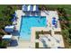 High-angle view of community pool featuring ample sun loungers, covered areas and beautiful landscaping at 204 Corvus St, Summerville, SC 29483
