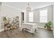 Well-lit dining room with hardwood floors, lots of plants, and a view to other living spaces at 204 Corvus St, Summerville, SC 29483