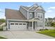 Charming two-story home with a two car garage and a well-manicured lawn at 204 Corvus St, Summerville, SC 29483