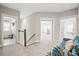 Upstairs hallway featuring carpeted floor, doorway to laundry room, and natural light at 204 Corvus St, Summerville, SC 29483