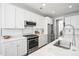 Kitchen featuring white cabinets, stainless steel appliances, marble countertops, and subway tile backsplash at 204 Corvus St, Summerville, SC 29483