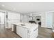 Modern kitchen with marble island, stainless appliances, and open floor plan to living area at 204 Corvus St, Summerville, SC 29483