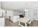 Bright kitchen with marble island, stainless appliances, open to dining area and staircase at 204 Corvus St, Summerville, SC 29483